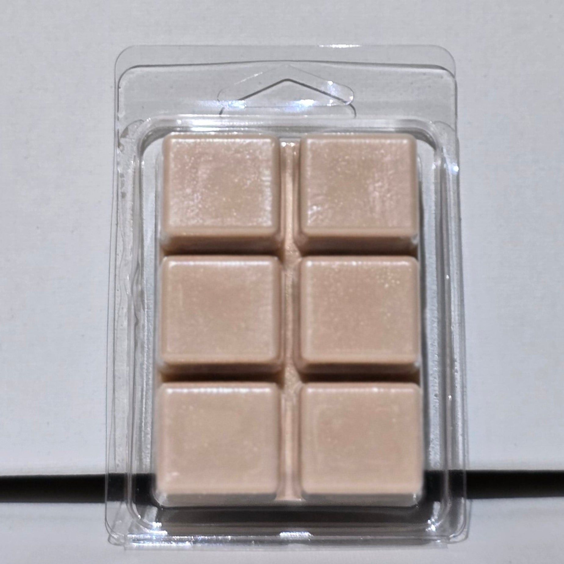 Pack of beige wax bars on a light gray background